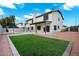 A well-maintained backyard offers a luxurious retreat with a covered patio and artificial grass at 2522 N Robin Ln, Mesa, AZ 85213