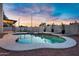 Backyard with a sparkling pool and spa, perfect for relaxation and entertaining, with a sunset background at 2522 N Robin Ln, Mesa, AZ 85213