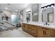 Bright bathroom with double vanities, a glass-enclosed shower, and modern fixtures at 2522 N Robin Ln, Mesa, AZ 85213