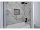 Stylish bathroom with a bathtub and shower featuring elegant marble tiles and a modern fixture at 2522 N Robin Ln, Mesa, AZ 85213