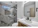 Beautiful bathroom with a glass shower, marble wall tiles, and sleek vanity with modern fixtures at 2522 N Robin Ln, Mesa, AZ 85213