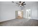 Bright carpeted bedroom boasts ceiling fan and doorways to other rooms at 2522 N Robin Ln, Mesa, AZ 85213
