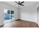 Bright bedroom with hardwood floors and a sliding glass door with a view of the pool at 2522 N Robin Ln, Mesa, AZ 85213