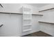 Bright walk-in closet offers open shelving and hanging rods for optimal organization at 2522 N Robin Ln, Mesa, AZ 85213