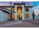 Charming two-story home with unique architectural details and a well-manicured desert landscape at 2522 N Robin Ln, Mesa, AZ 85213