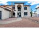 Inviting two-story home featuring desert landscaping, a tile roof, and an arched entryway at 2522 N Robin Ln, Mesa, AZ 85213