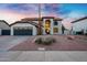 Charming two-story home with a gray garage door, arched entry, and desert landscaping at 2522 N Robin Ln, Mesa, AZ 85213