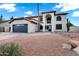 Charming two-story home with a gray garage door, arched entry, and desert landscaping at 2522 N Robin Ln, Mesa, AZ 85213