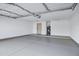 Spacious three-car garage with epoxy flooring and water heater at 2522 N Robin Ln, Mesa, AZ 85213