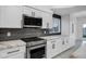 Close-up shot of stainless steel appliances, granite countertops, and custom backsplash in the kitchen at 2522 N Robin Ln, Mesa, AZ 85213