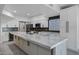 Renovated kitchen features white cabinets, stainless steel appliances, and a large island with seating at 2522 N Robin Ln, Mesa, AZ 85213