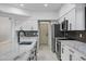 A modern kitchen is showcased with stainless steel appliances, granite countertops, and stylish cabinets at 2522 N Robin Ln, Mesa, AZ 85213
