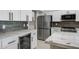 Modern kitchen featuring stainless steel appliances, granite countertops, and white cabinetry at 2522 N Robin Ln, Mesa, AZ 85213