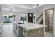 Open-concept kitchen featuring a large island, modern appliances, and a view into the living space at 2522 N Robin Ln, Mesa, AZ 85213