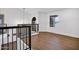 An open landing featuring contemporary railings, wood floors, a chandelier, and ample natural light at 2522 N Robin Ln, Mesa, AZ 85213