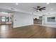 Spacious living room featuring wood floors, ceiling fan, and easy access to the kitchen at 2522 N Robin Ln, Mesa, AZ 85213
