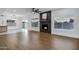Cozy living area featuring a modern fireplace, ceiling fan, and hardwood floors at 2522 N Robin Ln, Mesa, AZ 85213