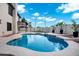 Backyard boasts a refreshing pool and spa, surrounded by a sleek patio and lush plants at 2522 N Robin Ln, Mesa, AZ 85213