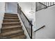 Carpeted staircase with iron railing leads to a bright, open living space at 2522 N Robin Ln, Mesa, AZ 85213