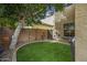 Serene backyard oasis with lush artificial turf, mature trees, and tasteful landscaping at 2673 E Remington Pl, Chandler, AZ 85286