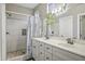 Modern bathroom featuring double sinks, decorative lighting, and a walk-in shower at 2673 E Remington Pl, Chandler, AZ 85286