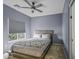 Inviting bedroom with a ceiling fan, a comfortable bed, and a bright window at 2673 E Remington Pl, Chandler, AZ 85286
