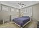 Calm bedroom featuring a ceiling fan, windows with shutters, and a cozy bed at 2673 E Remington Pl, Chandler, AZ 85286