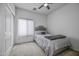 Cozy bedroom featuring a comfy bed, plush carpeting, and a modern ceiling fan at 2673 E Remington Pl, Chandler, AZ 85286