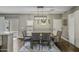 Neutral dining room featuring a decorative light fixture, dining table, and four woven chairs at 2673 E Remington Pl, Chandler, AZ 85286