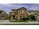Stunning two-story stucco home with a tile roof, arched windows, and a well-manicured lawn at 2673 E Remington Pl, Chandler, AZ 85286