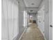 Neutral hallway featuring a neutral carpet, white walls, and bright doors at 2673 E Remington Pl, Chandler, AZ 85286