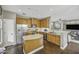 Functional kitchen featuring stainless steel appliances, ample wooden cabinets, and an island at 2673 E Remington Pl, Chandler, AZ 85286