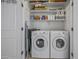 Efficient laundry room featuring a washer, dryer, and ample storage shelves at 2673 E Remington Pl, Chandler, AZ 85286