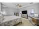 Spacious main bedroom with a TV, two arched windows, and an elegant ceiling fan at 2673 E Remington Pl, Chandler, AZ 85286