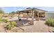 Lush backyard with a gazebo, brick patio, desert landscaping, and a covered patio view at 2857 N Mystic Ct, Casa Grande, AZ 85122