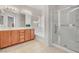 Well-lit bathroom with double vanity, a bathtub, and a glass-enclosed shower at 2857 N Mystic Ct, Casa Grande, AZ 85122