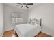 Cozy bedroom with a comfortable bed, hardwood floors, and a ceiling fan at 2857 N Mystic Ct, Casa Grande, AZ 85122
