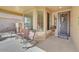 Cozy front porch with seating area, decorative door, and neutral colors at 2857 N Mystic Ct, Casa Grande, AZ 85122