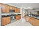 Well-lit kitchen featuring stainless steel appliances, wood cabinets and black countertops at 2857 N Mystic Ct, Casa Grande, AZ 85122