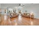 Spacious living room with hardwood floors, ceiling fan, and light-filled open floor plan at 2857 N Mystic Ct, Casa Grande, AZ 85122