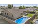 Aerial view of backyard with pool, spa, lush artificial turf, and meticulous landscaping for outdoor enjoyment at 2894 E Nolan Pl, Chandler, AZ 85249