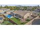 Spacious backyard features lush artificial turf, a sparkling pool, a covered patio, and mature landscaping at 2894 E Nolan Pl, Chandler, AZ 85249