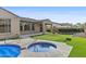 Backyard featuring a sparkling spa, artificial turf and outdoor seating area at 2894 E Nolan Pl, Chandler, AZ 85249