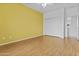 Bedroom featuring wood floors, a sliding door closet, and access to a bathroom at 2894 E Nolan Pl, Chandler, AZ 85249