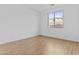 Bright bedroom with wood flooring, a large window with neighborhood views, and neutral paint at 2894 E Nolan Pl, Chandler, AZ 85249