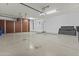 Spacious garage with epoxy floors, built-in storage, and modern lighting at 2894 E Nolan Pl, Chandler, AZ 85249