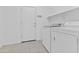Laundry room with appliances, tile floor, shelving, and access to the garage at 2894 E Nolan Pl, Chandler, AZ 85249
