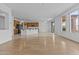 Open floor plan showcasing a living room and kitchen with wood floors, plenty of sunlight, and neutral colors at 2894 E Nolan Pl, Chandler, AZ 85249