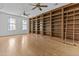 Bright living room with hardwood floors, built-in bookshelves, and large windows for natural light at 2894 E Nolan Pl, Chandler, AZ 85249