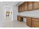 Home office nook with desk space, upper and lower cabinets, and tile flooring at 2894 E Nolan Pl, Chandler, AZ 85249